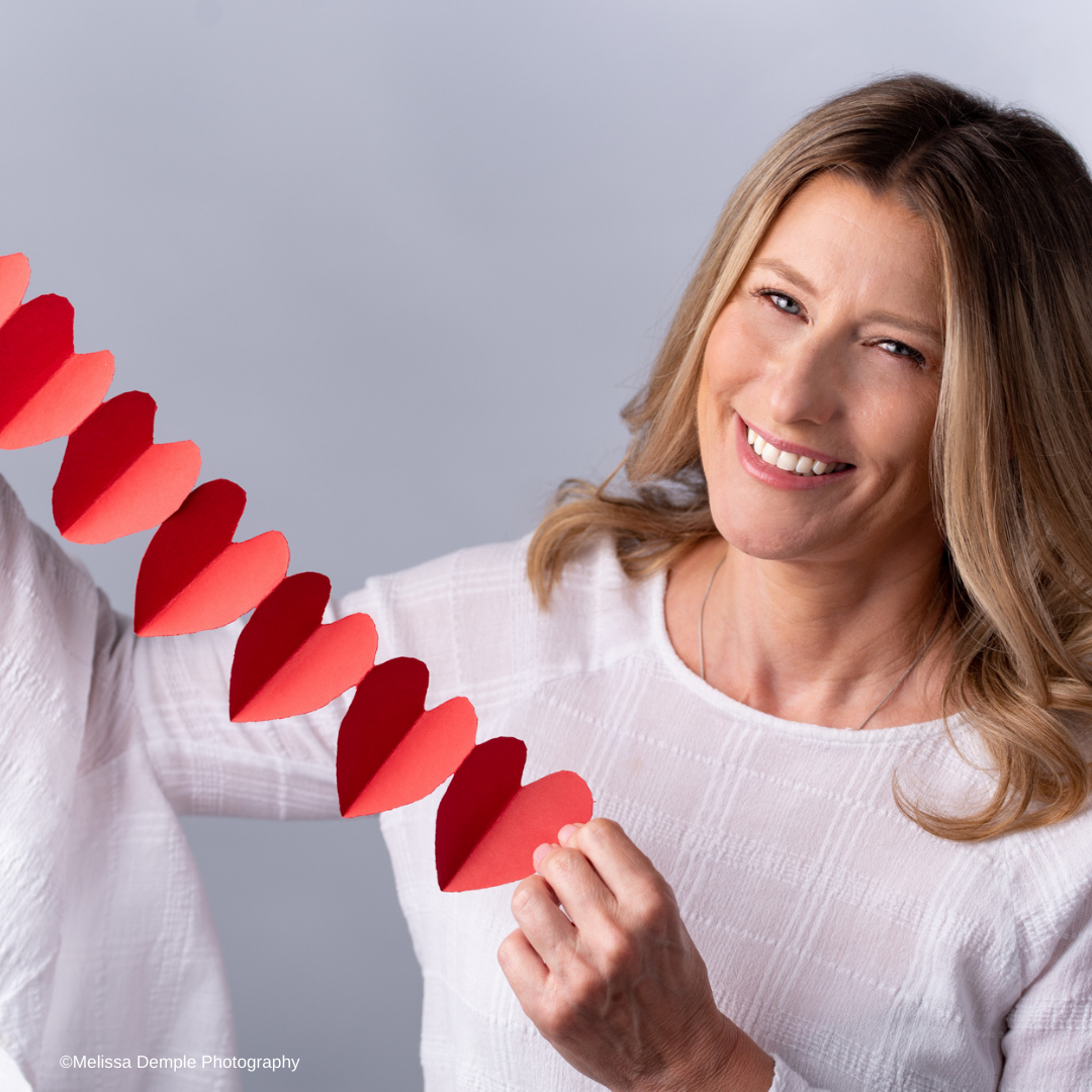 lady holding cut out hearts