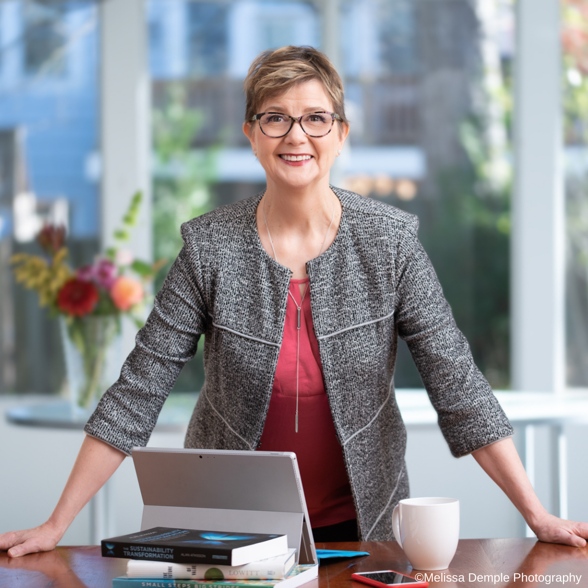 Confident woman standing behind a desk