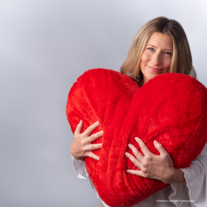 Love your brand - lady hugging a large heart pillow