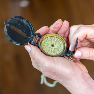 Woman holding a compass looking for direction