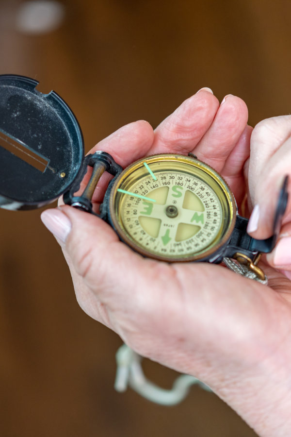 Woman holding a compass looking for direction